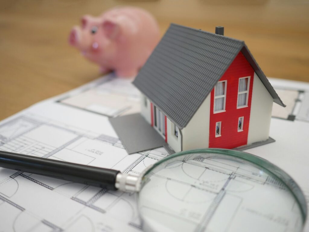 Real estate investment; the image of small house above a plan