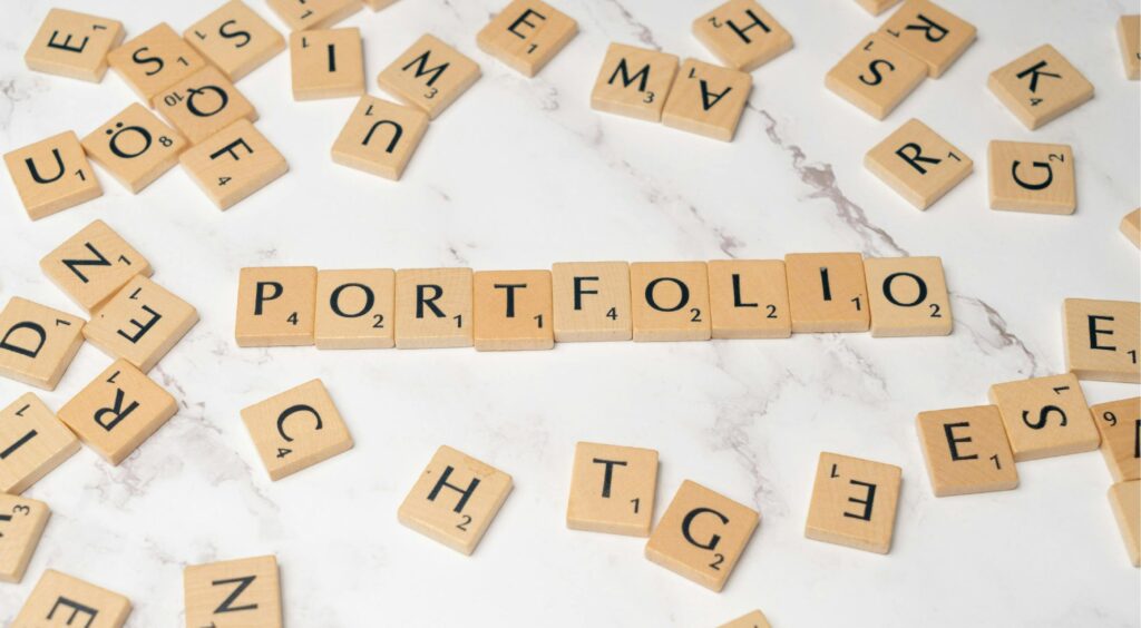  Scrabble tiles spelling out 'PORTFOLIO' on a marble surface, emphasizing the importance of portfolio rebalancing in financial planning.
