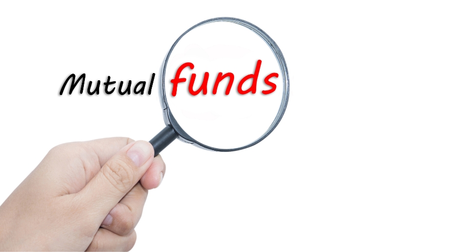 Hand holding a magnifying glass focusing on the words 'Mutual funds,' emphasizing the importance of choosing the right mutual funds.